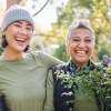 a mother and daughter gardening