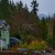 a small house with a car parked in the driveway