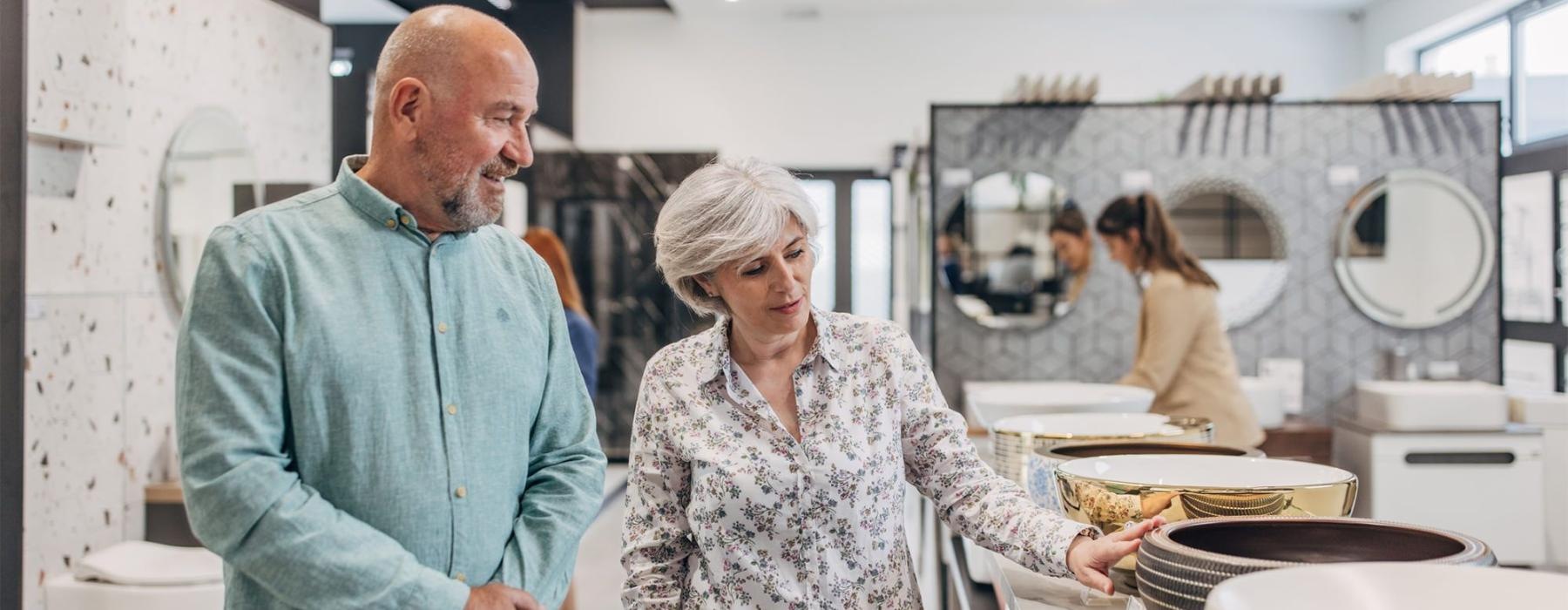 a man and woman shopping for dishes